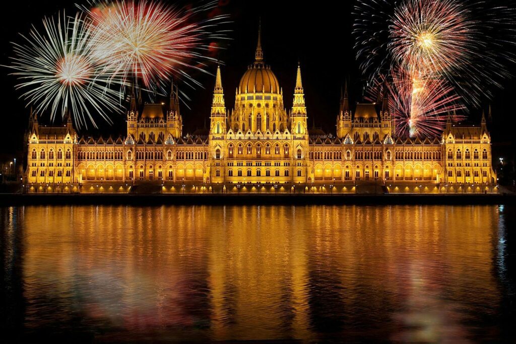 Budapest Parliament building in Hungary at night with fireworks, highlighting Hungary as a low-tax jurisdiction in Europe for businesses and investors
