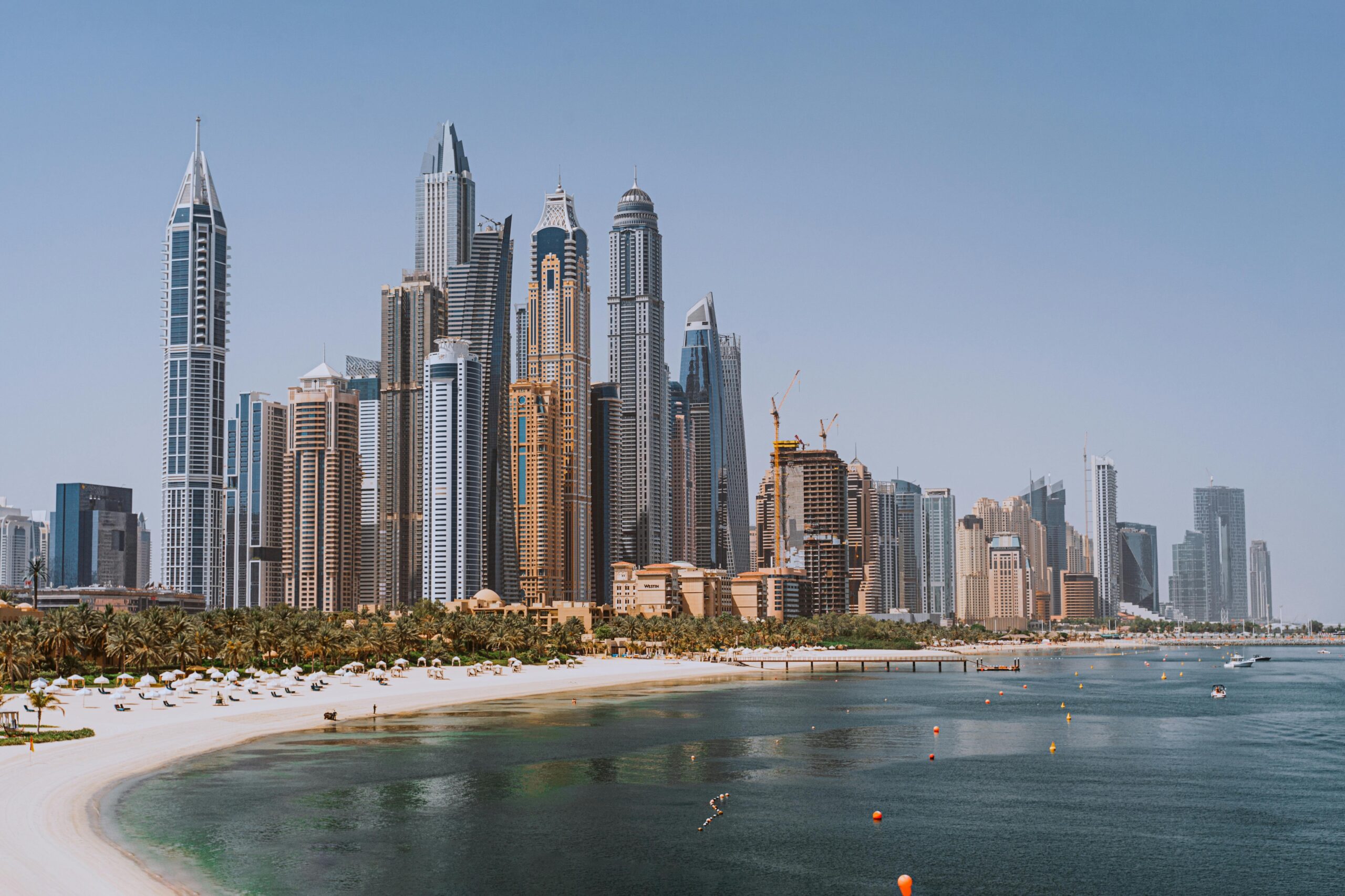 Dubai Marina skyline viewed from the beach, showcasing Dubai’s modern urban development and world-class infrastructure.