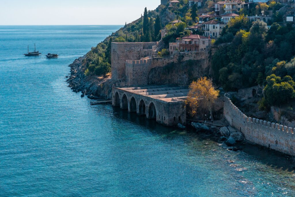 Ancient Seljuk shipyard in Alanya along the Mediterranean coast, with its stone arches and hilltop fortress overlooking the sea