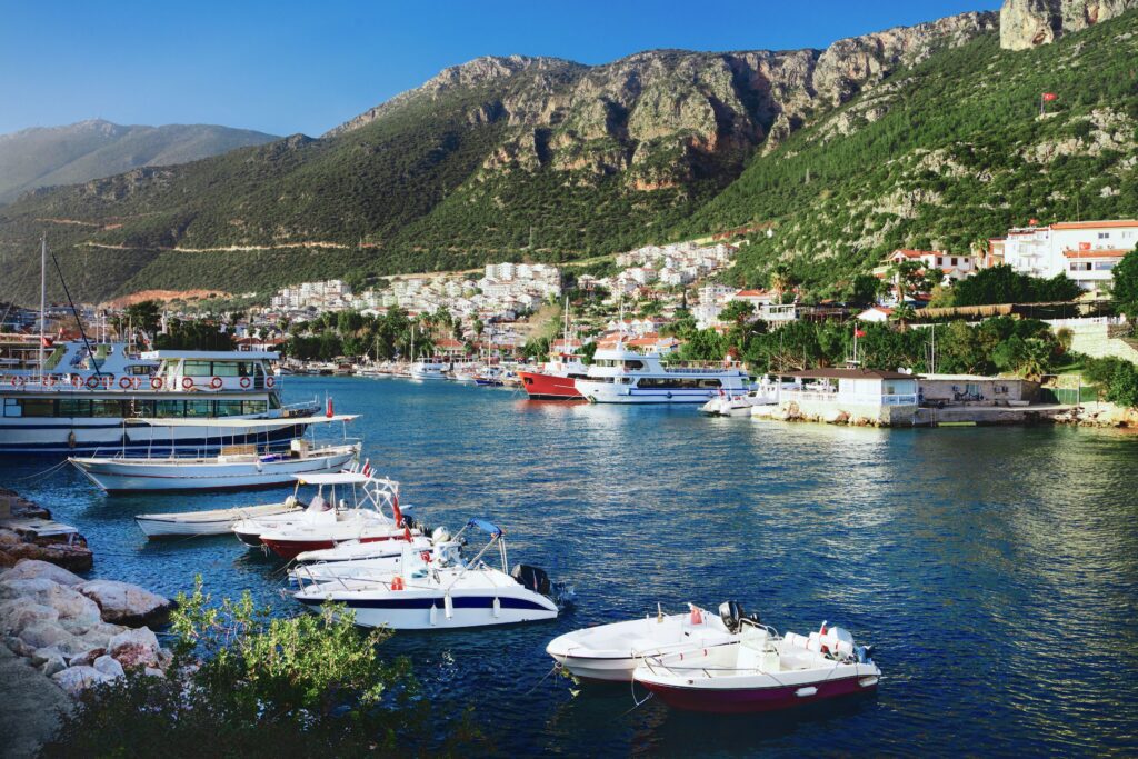 Harbour of Kaş with moored boats and mountain backdrop, one of the most scenic spots on Turkey's Mediterranean coastline