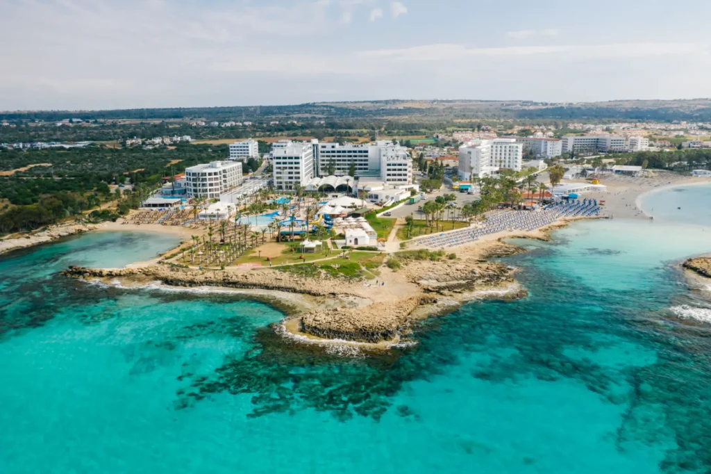 Aerial view of turquoise water and beachfront hotels on the Cyprus coastline
