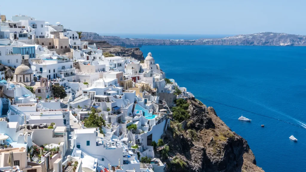 Whitewashed cliffside houses overlooking the deep blue Aegean sea in Santorini